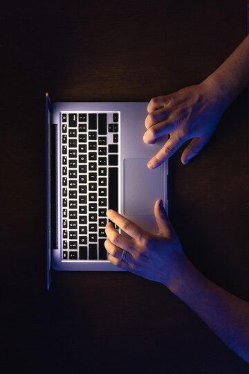 male-hands-working-laptop-night-top-view_169016-51265