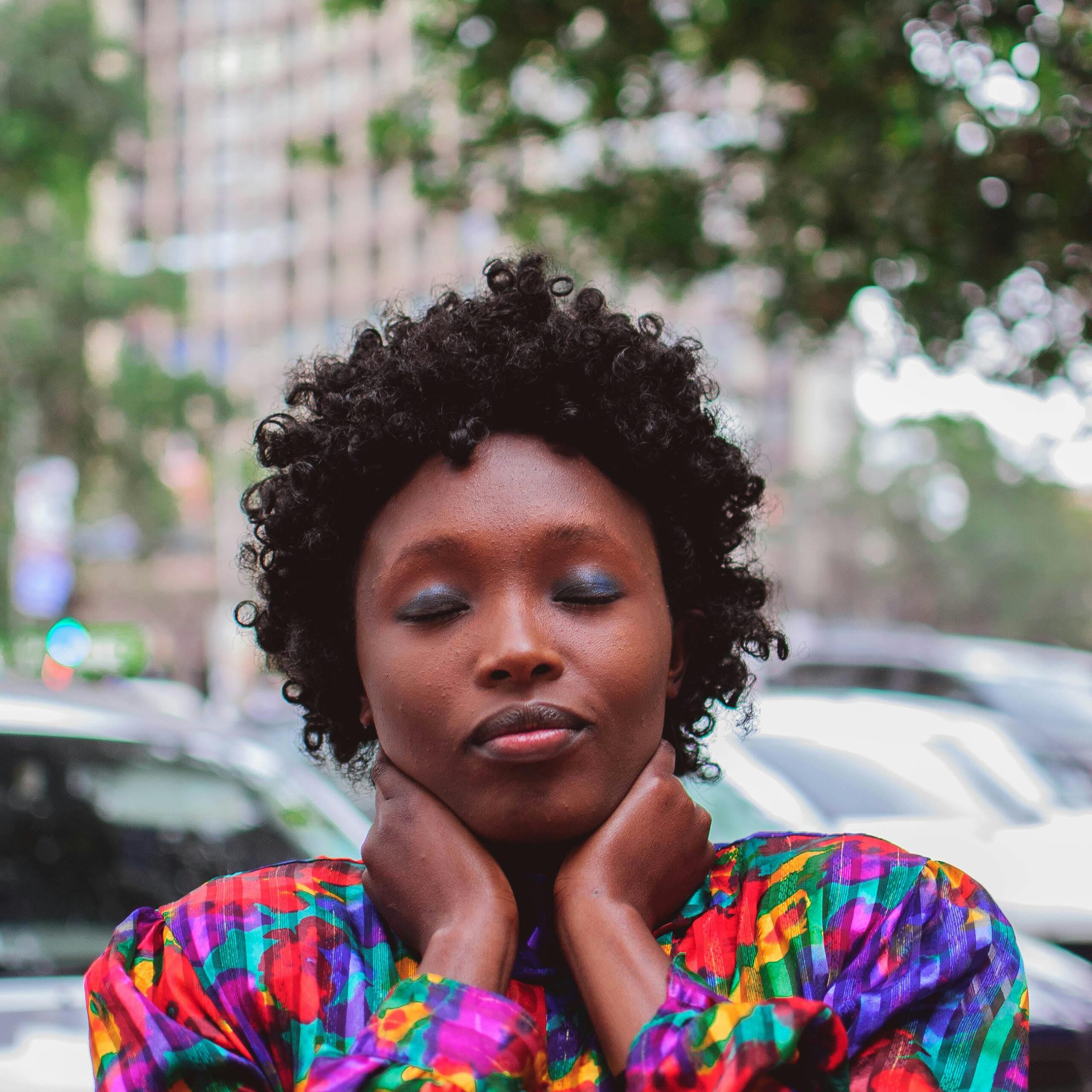 A serene portrait of an African woman with eyes closed, captured in Nairobi.